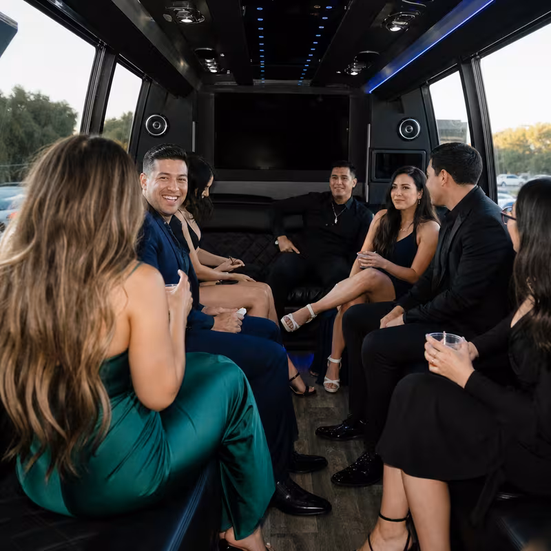 Party bus interior with wraparound leather seating and LED lighting in Santa Clarita