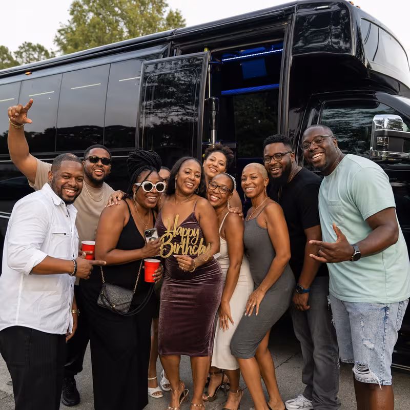 Group boarding a white charter bus for Birthday Transportation transportation in Santa Clarita