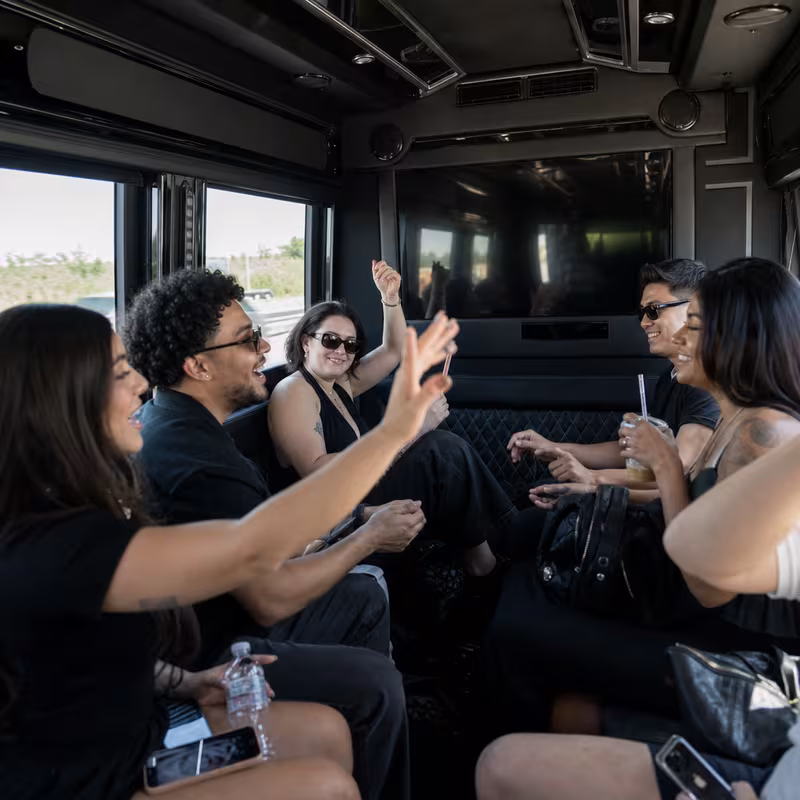 Group boarding a white charter bus for Concert Transportation transportation in Santa Clarita