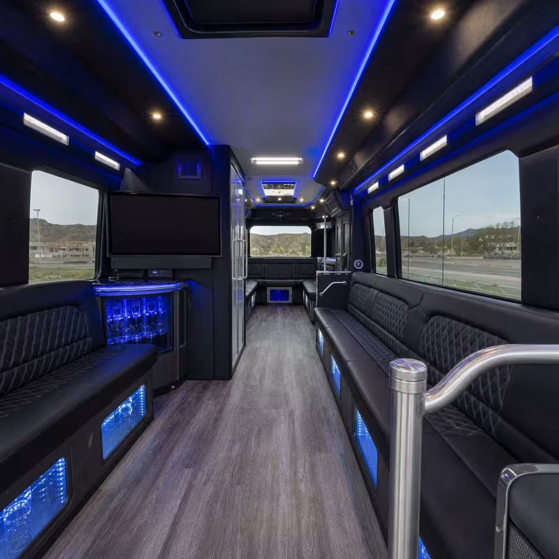 Party bus interior with wraparound leather seating and LED lighting in Santa Clarita