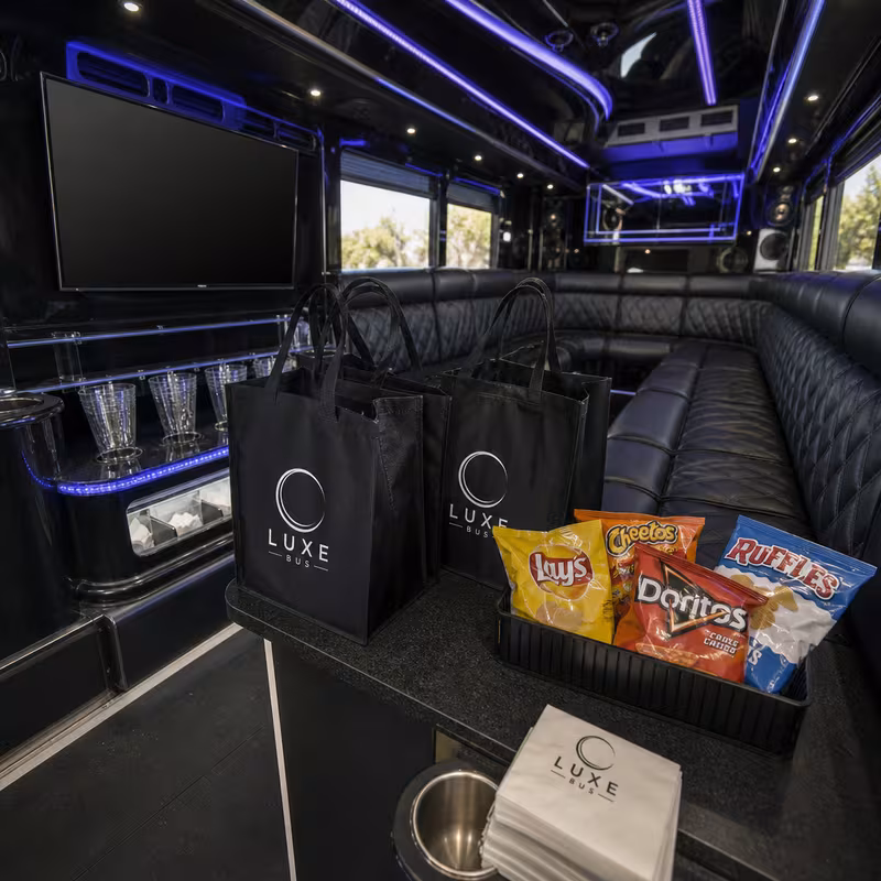 Party bus interior with wraparound leather seating and LED lighting in Santa Clarita